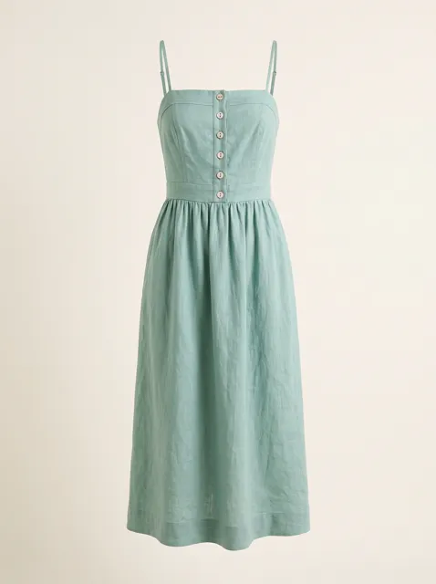 The green linen dress from the front, on a plain background